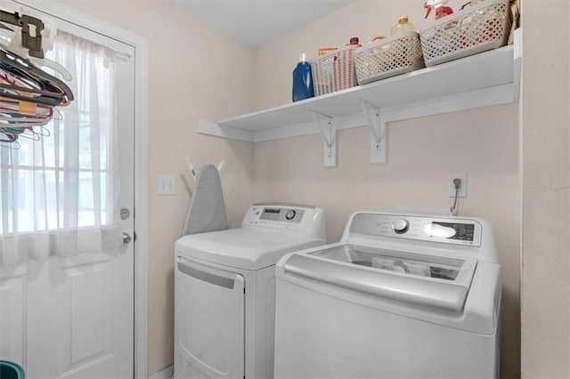 washroom featuring laundry area and washing machine and clothes dryer