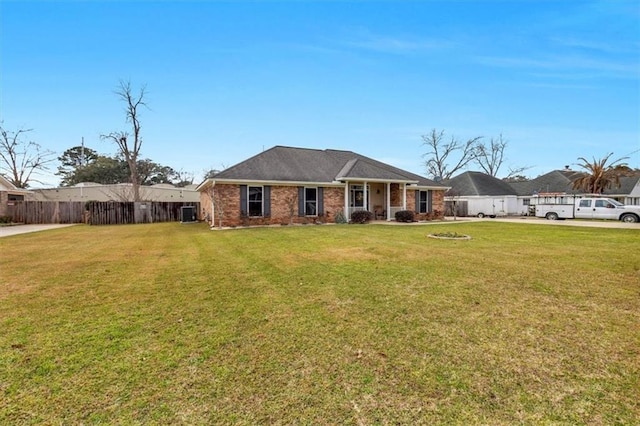 single story home with brick siding, a front yard, and fence