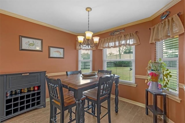 dining space featuring baseboards, wood tiled floor, ornamental molding, and a notable chandelier