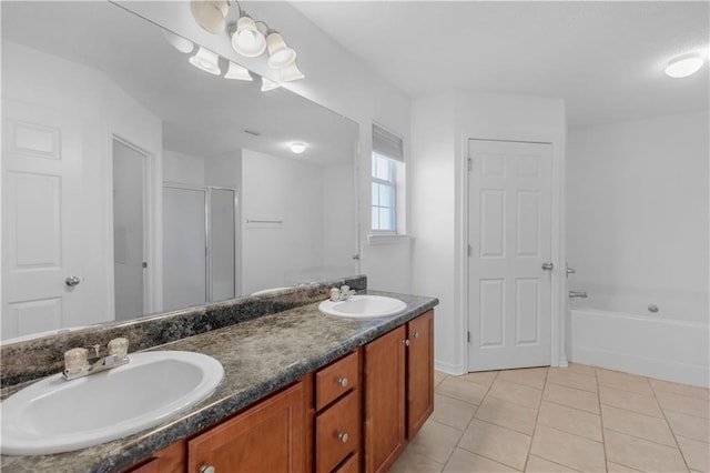 bathroom featuring vanity, shower with separate bathtub, and tile patterned floors