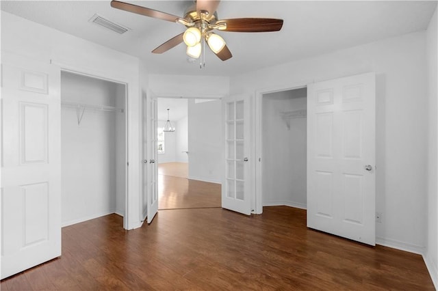 unfurnished bedroom with french doors, dark hardwood / wood-style floors, and ceiling fan