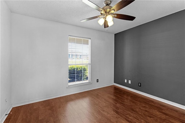 spare room with a textured ceiling, wood-type flooring, and ceiling fan