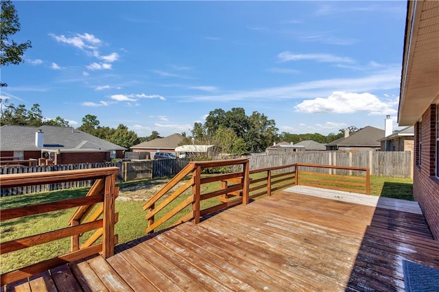 wooden terrace featuring a lawn