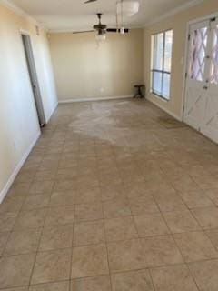 spare room featuring crown molding and ceiling fan