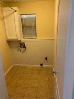 laundry area with light tile patterned floors and hookup for an electric dryer