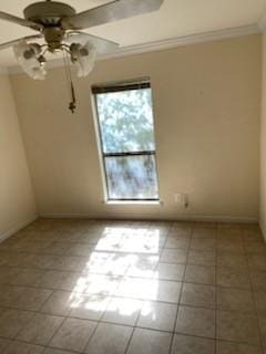 tiled spare room with ornamental molding and ceiling fan