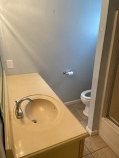 bathroom with tile patterned flooring, sink, and toilet