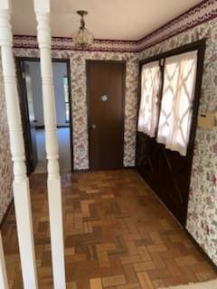 interior space featuring parquet flooring and ornate columns