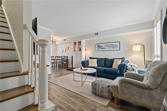 living room with crown molding and wood-type flooring