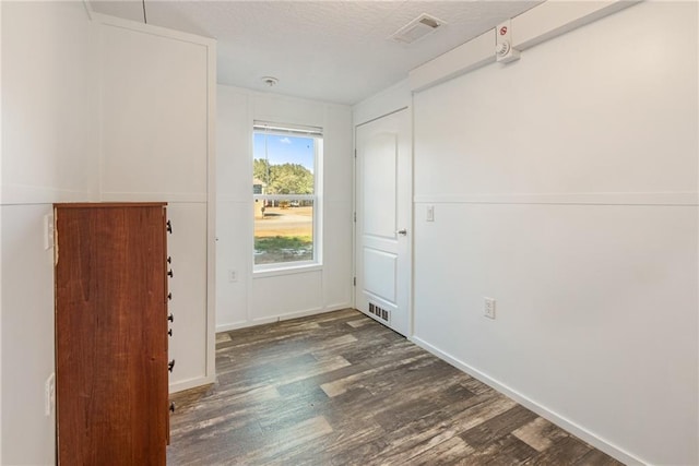 interior space with dark hardwood / wood-style floors and a textured ceiling