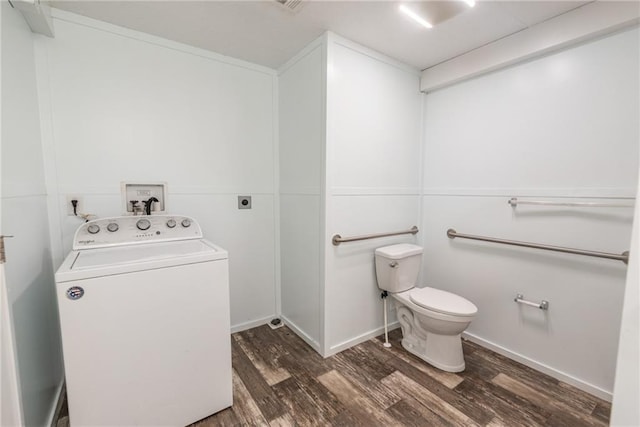 bathroom featuring hardwood / wood-style flooring, toilet, and washer / dryer