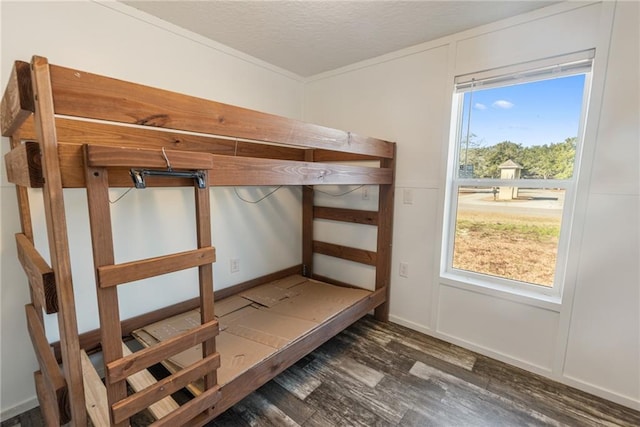 unfurnished bedroom with dark wood-type flooring and a textured ceiling