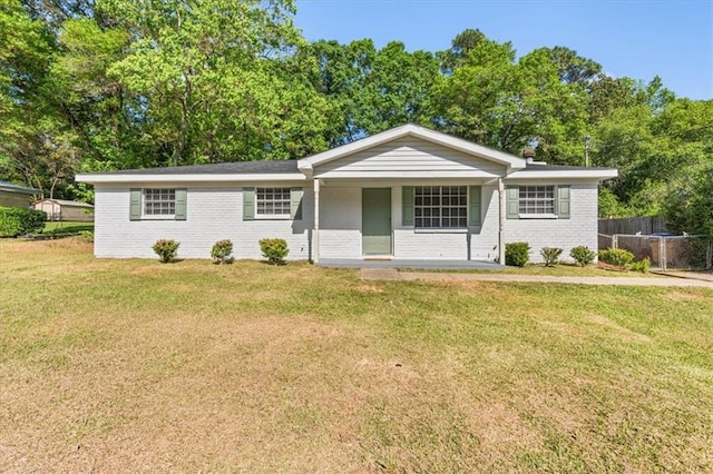 single story home featuring fence, covered porch, a front yard, and brick siding