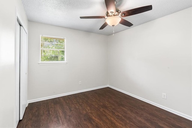 unfurnished room with wood finished floors, a textured ceiling, baseboards, and ceiling fan