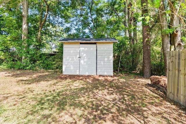 view of shed featuring fence