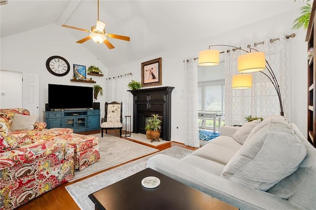 living room featuring hardwood / wood-style flooring, ceiling fan, and high vaulted ceiling