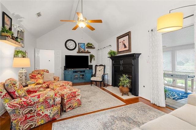 living room featuring hardwood / wood-style floors, high vaulted ceiling, and ceiling fan