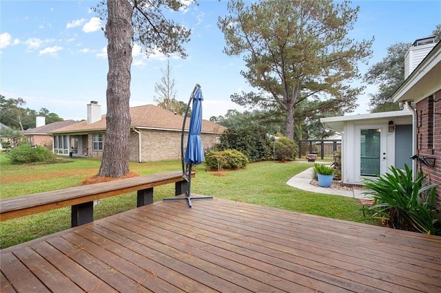 wooden terrace with a yard