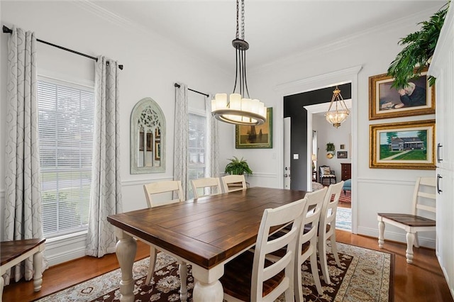 dining space with plenty of natural light, ornamental molding, and hardwood / wood-style flooring