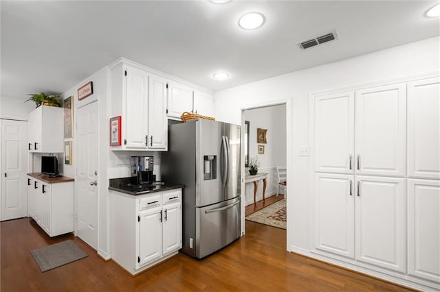 kitchen featuring white cabinetry, dark wood-type flooring, and stainless steel refrigerator with ice dispenser