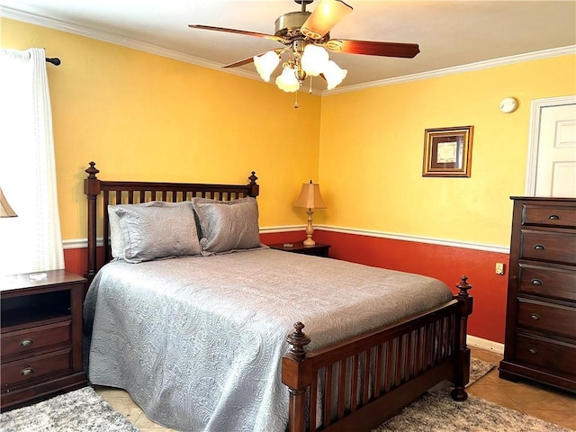 tiled bedroom with ceiling fan and crown molding