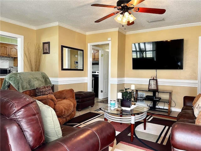 living room featuring a textured ceiling, ceiling fan, and crown molding