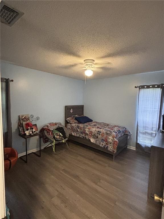 1205 Cadiz St, Mobile, AL 36693 - bedroom featuring visible vents, a textured ceiling, dark wood finished floors, and a ceiling fan