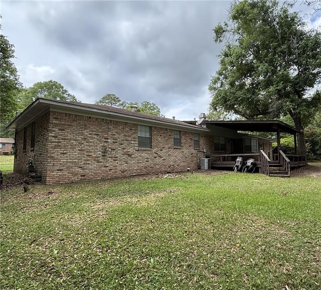 1205 Cadiz St, Mobile, AL 36693 - rear view of house featuring a lawn, covered porch, cooling unit, and brick siding