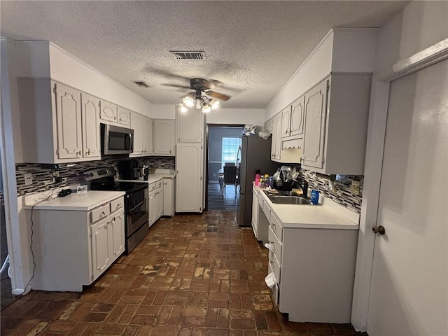 1205 Cadiz St, Mobile, AL 36693 - kitchen featuring a ceiling fan, appliances with stainless steel finishes, backsplash, and light countertops