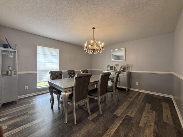 1205 Cadiz St, Mobile, AL 36693 - dining space with a textured ceiling, baseboards, a notable chandelier, and dark wood-style floors