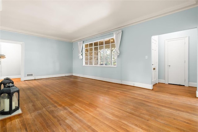 unfurnished living room with light hardwood / wood-style floors and crown molding