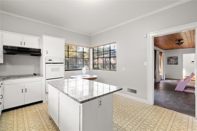 kitchen featuring a kitchen island, white cabinetry, double oven, and wooden ceiling