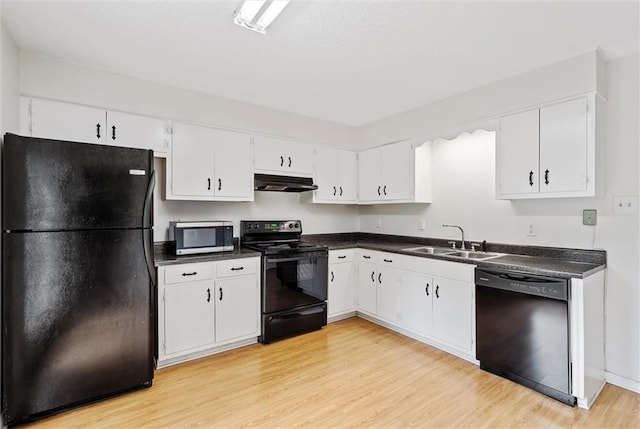 kitchen with black appliances, light hardwood / wood-style floors, white cabinetry, and sink