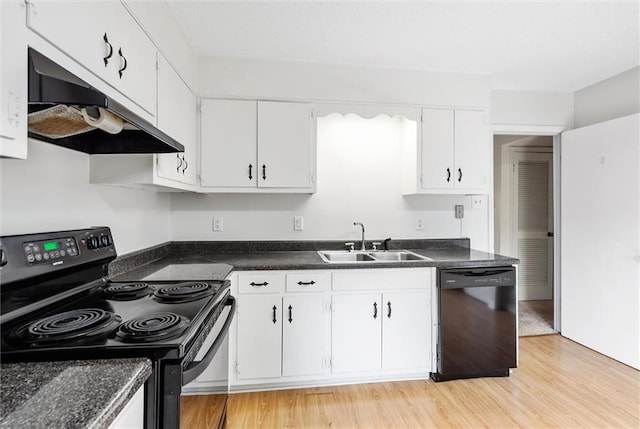 kitchen featuring white cabinets, black appliances, light wood-type flooring, and sink