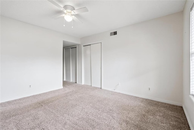 unfurnished bedroom with ceiling fan and carpet flooring