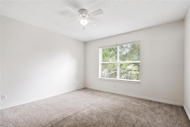 spare room featuring a textured ceiling, ceiling fan, and carpet floors