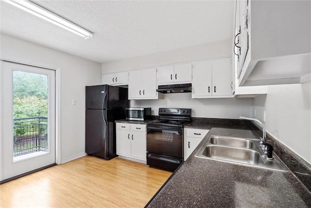 kitchen featuring a wealth of natural light, sink, white cabinetry, and black appliances