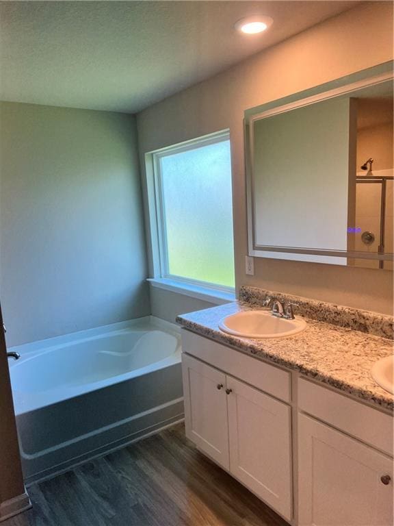 6157 Stream Bank Dr, Mobile, AL 36582 - bathroom with a sink, double vanity, wood finished floors, and a garden tub