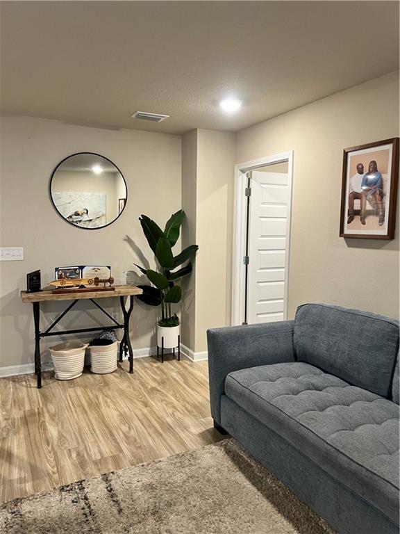 6157 Stream Bank Dr, Mobile, AL 36582 - sitting room with wood finished floors, baseboards, and visible vents