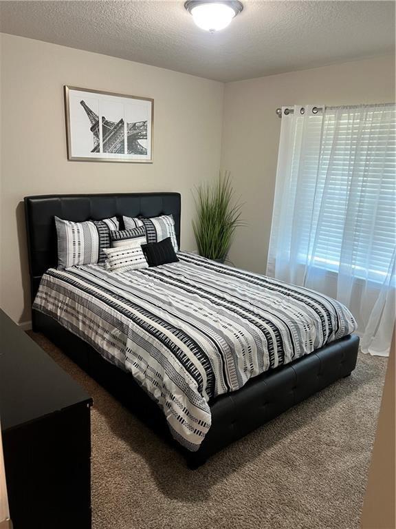 6157 Stream Bank Dr, Mobile, AL 36582 - bedroom featuring carpet flooring and a textured ceiling