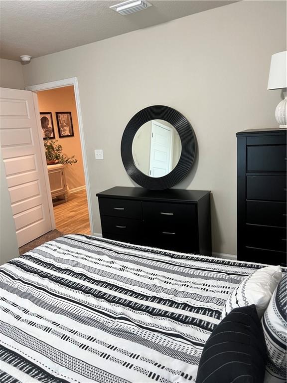 6157 Stream Bank Dr, Mobile, AL 36582 - bedroom with light wood-style floors and visible vents