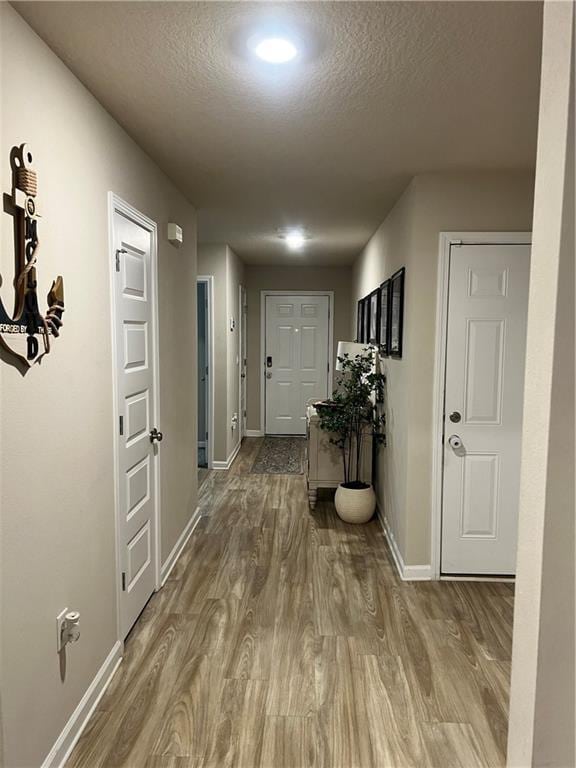 6157 Stream Bank Dr, Mobile, AL 36582 - corridor featuring a textured ceiling, wood finished floors, and baseboards