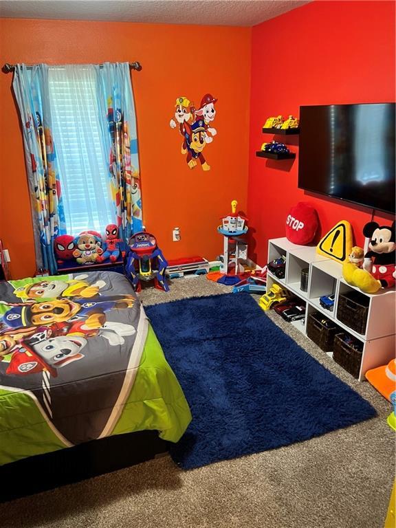 6157 Stream Bank Dr, Mobile, AL 36582 - recreation room featuring a textured ceiling and carpet floors