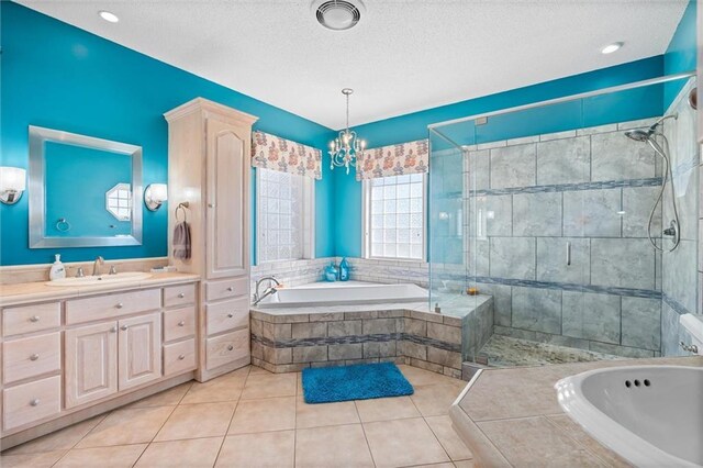 bathroom with a bath, a stall shower, vanity, and tile patterned floors