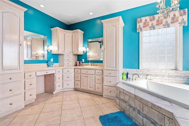 bathroom featuring tile patterned floors, a garden tub, vanity, a notable chandelier, and recessed lighting