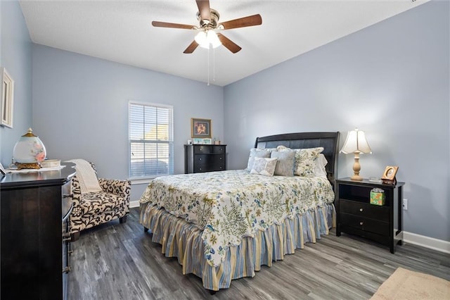 bedroom featuring a ceiling fan, baseboards, and wood finished floors