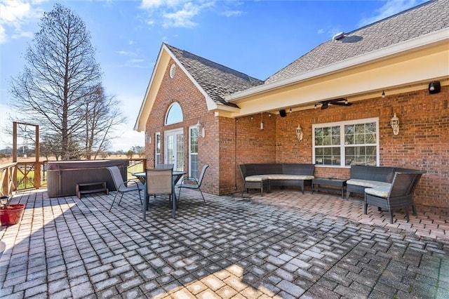 view of patio / terrace with a ceiling fan, french doors, outdoor lounge area, and a hot tub