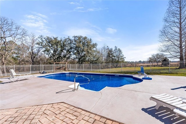 view of swimming pool featuring a patio area, fence, and a fenced in pool