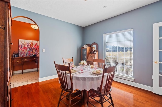 dining room with baseboards and wood finished floors