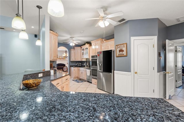 kitchen featuring light tile patterned flooring, visible vents, appliances with stainless steel finishes, light brown cabinetry, and glass insert cabinets